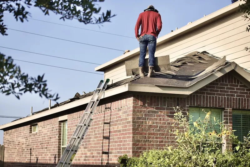 Professional roofer working on a residential roof in Canova